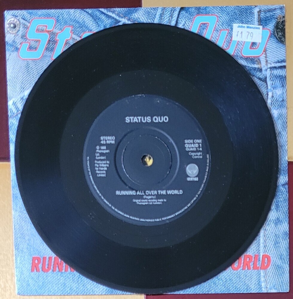 The actual disc of Status Quo's Running All Over The World with lyrics by Fogerty